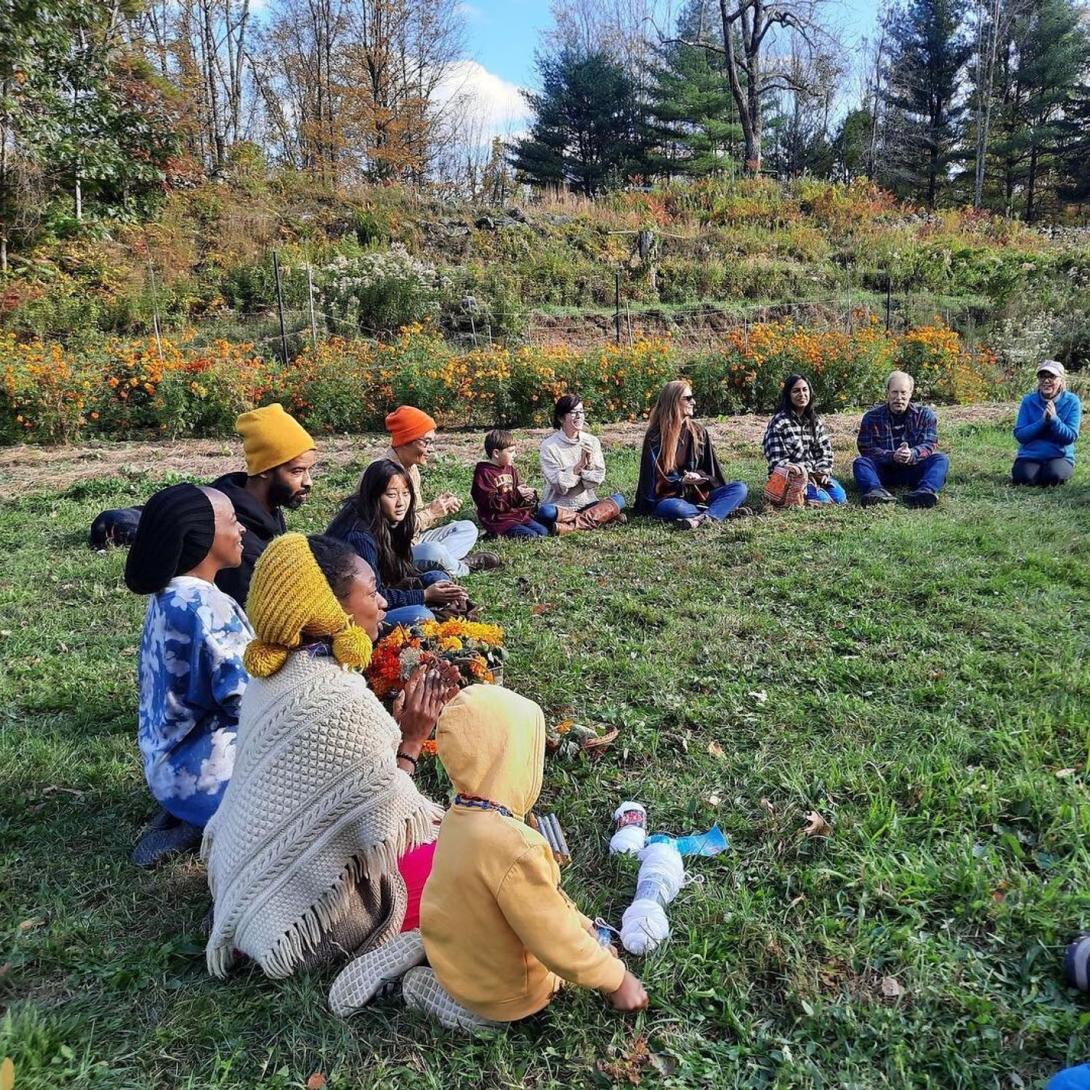 Mumbet's Freedom Farm group sitting in a circle on the grass.