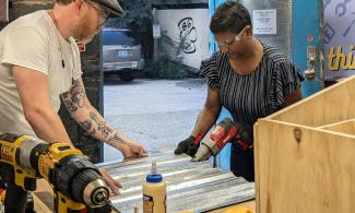 Devon Curtin helps teach a little free library workshop at PVD Things in 2024